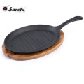 cast iron skillet sizzling plate with vegetable oil coating fajita pan